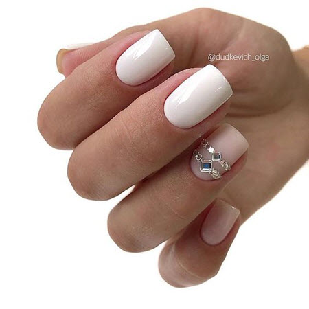 White manicure with stones and rhinestones
