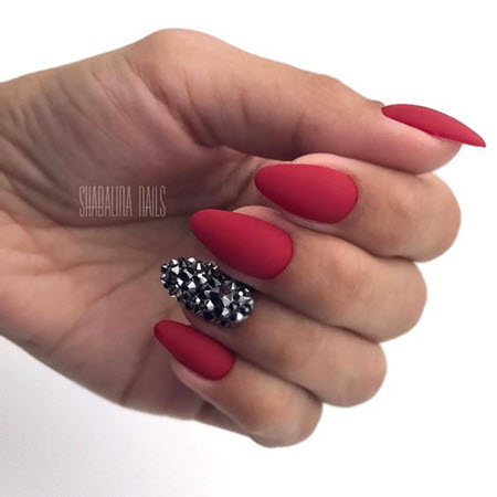 Red manicure with stones and rhinestones
